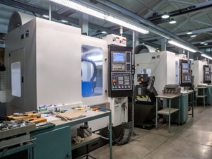 A spacious room filled with multiple CNC machines, showcasing a modern manufacturing environment.